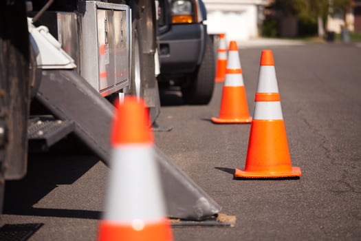 Orange Hazard Cones and Utility Truck in Street photo
