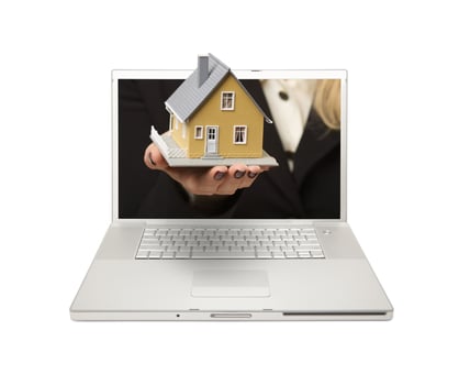 Woman Handing House Through Laptop Screen photo