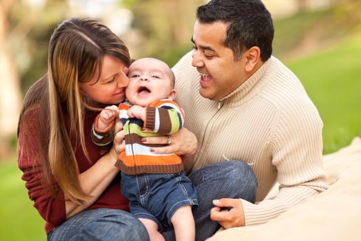 Happy Mixed Race Parents Playing with Their Son photo