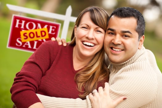Mixed Race Couple in Front of Sold Real Estate Sign photo