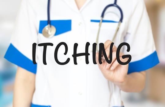 itching word with doctor's hand and marker photo