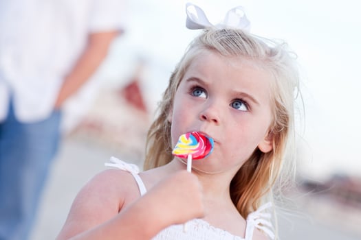 Adorable Little Girl Enjoying Her Lollipop Outside photo