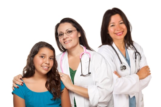 Hispanic Female Doctor with Child Patient and Colleague Behind photo