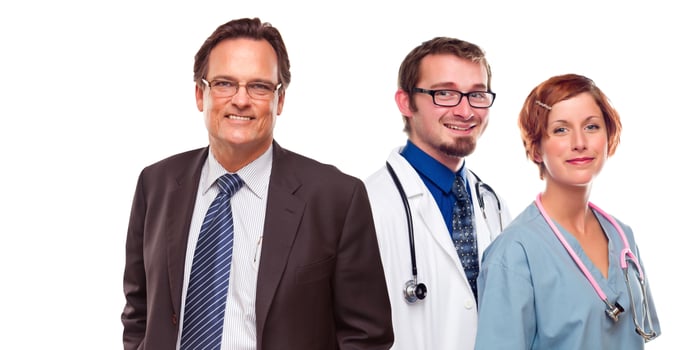 Friendly Male and Female Doctors with Businessman on White photo