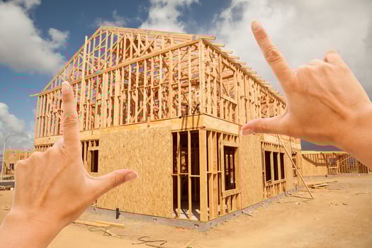 Female Hands Framing Home Frame on Construction Site photo