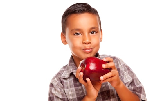 Adorable Hispanic Boy Eating a Large Red Apple photo