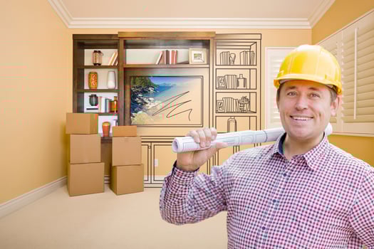 Male Construction Worker In Room With Drawing of Entertainment Unit photo