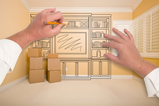 Hands Drawing Entertainment Unit In Room With Moving Boxes photo