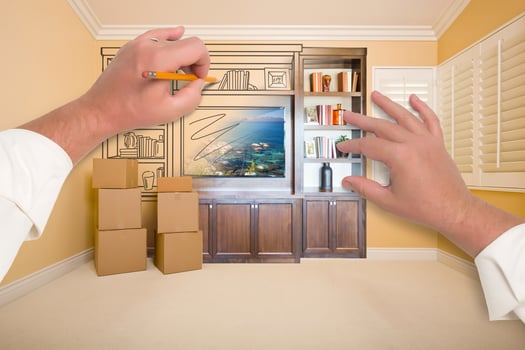 Hands Drawing Entertainment Unit In Room With Moving Boxes photo