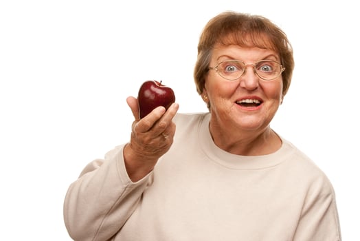 Attractive Senior Woman with Red Apple photo
