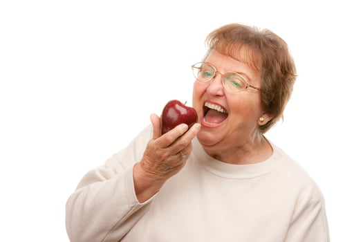 Attractive Senior Woman with Apple photo