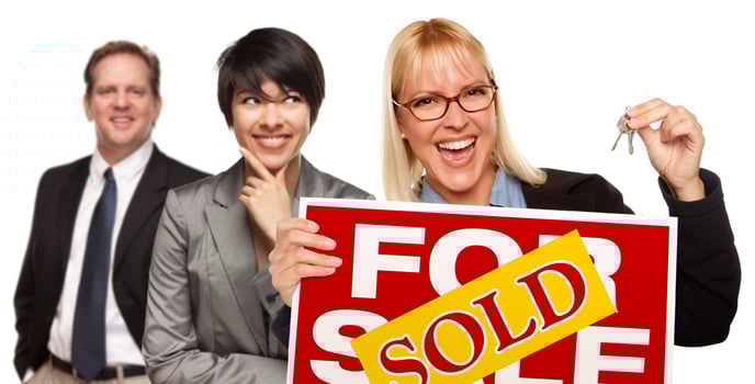 Real Estate Team with Woman Holding Keys and Sold For Sale Sign photo