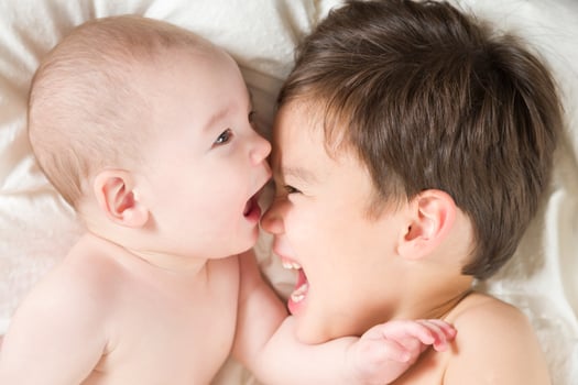 Mixed Race Chinese and Caucasian Baby Brothers Having Fun Laying on Their Blanket photo