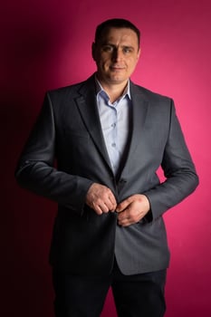 handsome businessman in a suit looks at the camera. photo