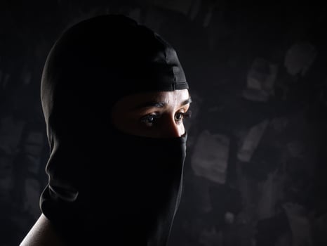 Portrait of a girl in a black balaclava and a black bra. photo
