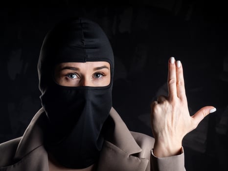 Portrait of a girl in a black balaclava and beige coat. photo