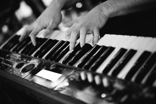 a musician plays keyboard instruments at a concert. photo