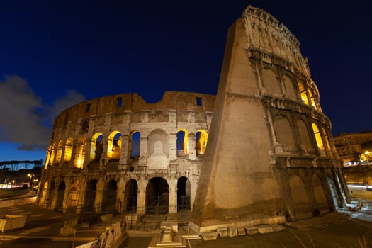 rome, italy, colosseum old ancient building gladiator battle at night. photo