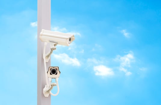 Outdoor white CCTV on pole with blue sky background and copy space photo