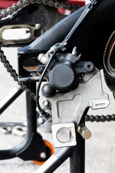 Close up rear brake motorcycle with back view motorcycle up to stand to remove wheel to change tire photo