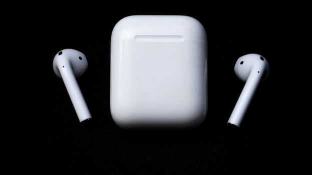 White ear pods with black isolated background, detail close up wireless earphone for daily smart phone entertainment and connectivity. photo