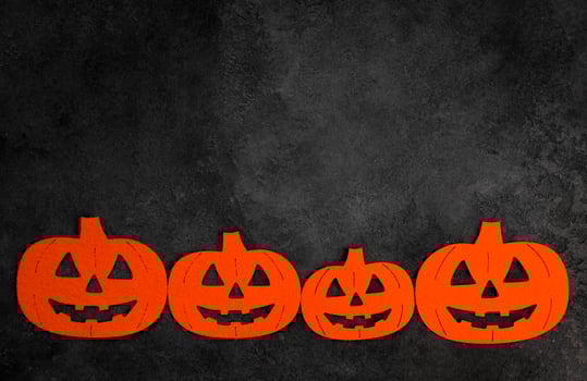 Halloween flat lay with felt pumpinks in black concrete background.Banner with place for text. photo