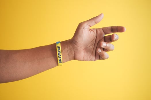 Hand with blue and yellow wristband , colors of flag of Ukraine. photo