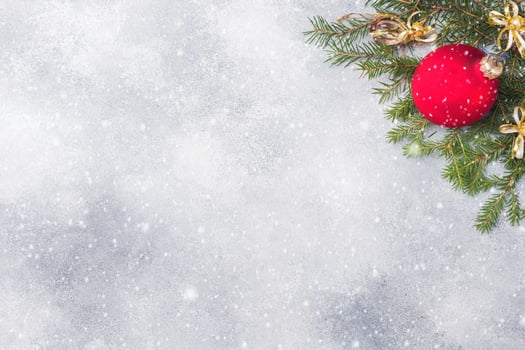 Christmas scenery, toys and branches fir on grey background. New Year concept Copy space photo