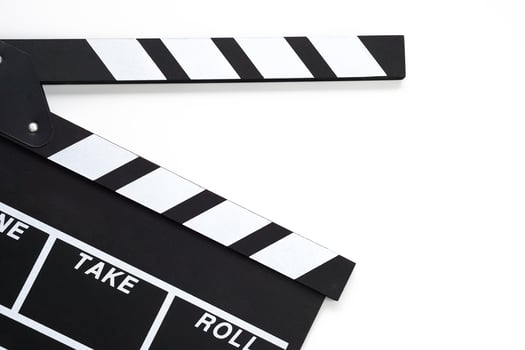 Clapperboard or movie slate black color on white background. Cinema industry, video production and film concept. photo