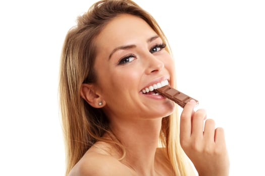 Portrait of beautiful woman holding chocolate bar photo