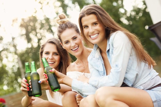 Happy group of friends drinking beer outdoors photo