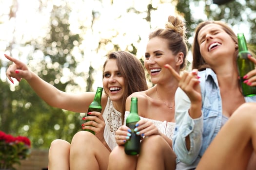 Happy group of friends drinking beer outdoors photo
