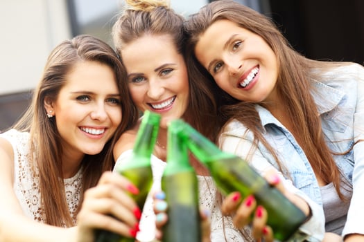 Happy group of friends drinking beer outdoors photo