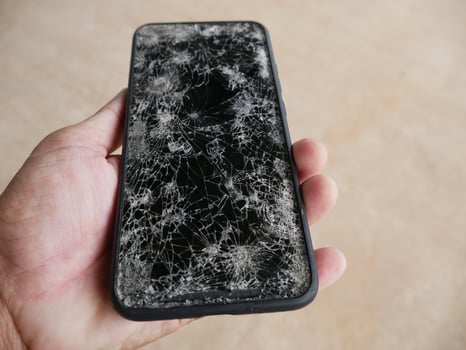 The smartphone hit the floor, it fell into a crack. photo