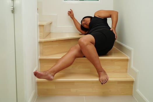 Asian lady woman injury from falling down on slippery surfaces stairs at home. photo