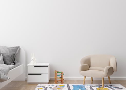 Empty white wall in modern child room. Mock up interior in contemporary style. Free space, copy space for your picture, text, or another design. Bed, armchair, toys. Cozy room for kids. 3D rendering. photo