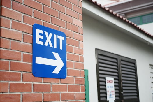 exit sign on brick wall photo
