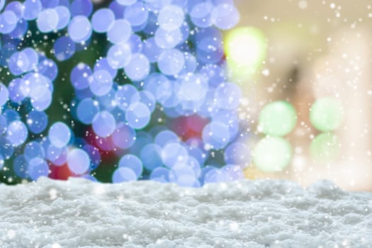 Empty white snow with blur Christmas tree with bokeh light background photo