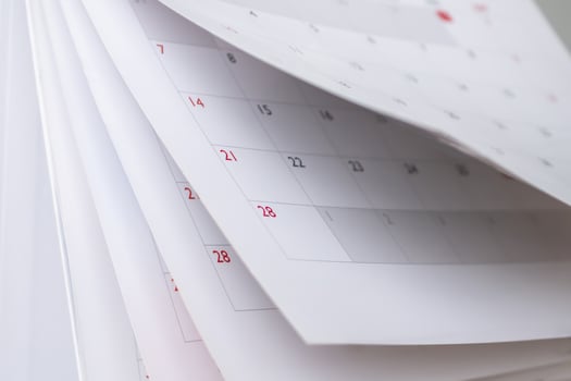 Calendar page flipping sheet close up blur background business schedule planning appointment meeting concept photo