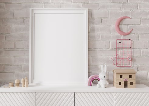 Empty vertical picture frame standing on white sideboard in modern child room. Mock up interior in scandinavian style. Free, copy space for your picture, poster. Close-up view. 3D rendering. photo