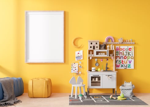 Empty vertical picture frame on yellow wall in modern child room. Mock up interior in scandinavian style. Free, copy space for your picture. Play kitchen, toys. Cozy room for kids. 3D rendering. photo