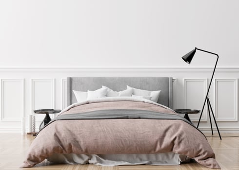 Empty white wall in modern and cozy bedroom. Mock up interior in classic style. Free space, copy space for your picture, text, or another design. Bed, lamp, parquet floor. 3D rendering. photo