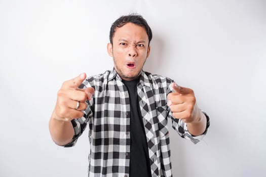The angry and mad face of Asian man in tartan shirt on isolated white background. photo