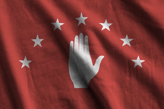Abkhazia flag with big folds waving close up under the studio light indoors. The official symbols and colors in banner photo