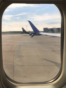 Airplane wing with beautiful sky from airplane window photo