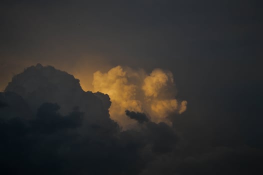 Dark clouds, clouds on in the dark sky. Stormy weather, sun shining through the clouds. photo