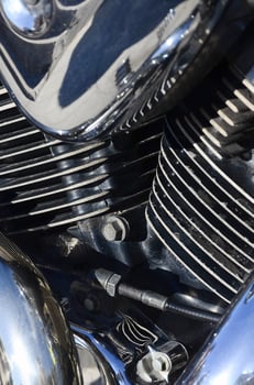 Fragment of chromed shiny body part of old classic motorbike photo