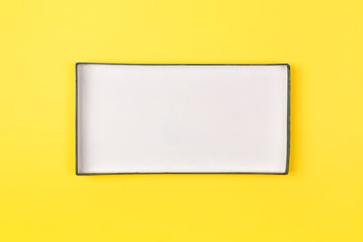 Empty box for product on yellow background. top view photo