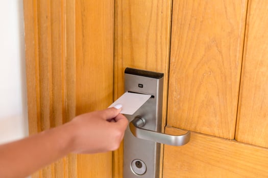 Woman hand with keycard in the electronic lock. female hand hold key card and open electronic lock door photo