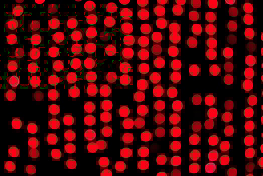 Unfocused abstract red bokeh on black background. defocused and blurred many round light photo